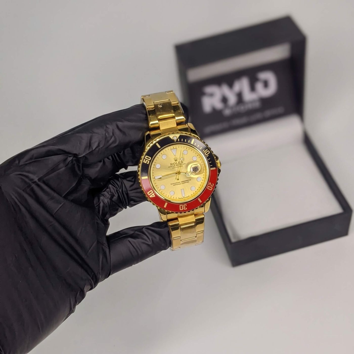Two-tone steel and gold watch, white dial, red bezel